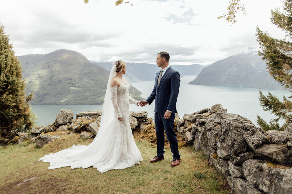 American couple celebrating their intimate cruise elopement with a scenic view over Lustrafjord in Norway